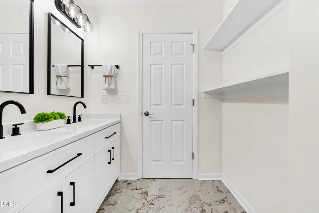 a view of bathroom with dual sinks