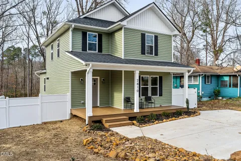 front view of a house with a chair and table