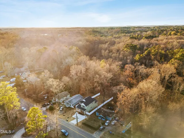 an aerial view of house with yard and mountain view in back