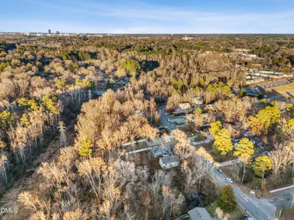 an aerial view of residential building and trees around