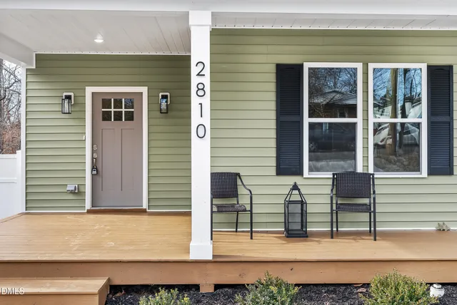 a view of a house with wooden fence