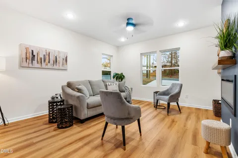 a living room with furniture and wooden floor