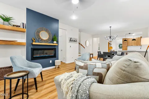 a living room with furniture kitchen view and a fireplace