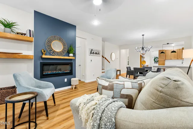 a living room with furniture kitchen view and a fireplace