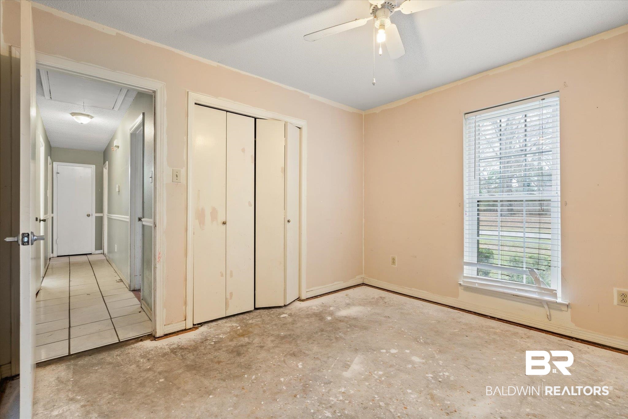 3541 Winston Drive Semmes, AL 36575 - Photo 12 of 20 Unfurnished bedroom featuring attic access, concrete floors, a ceiling fan, and a closet