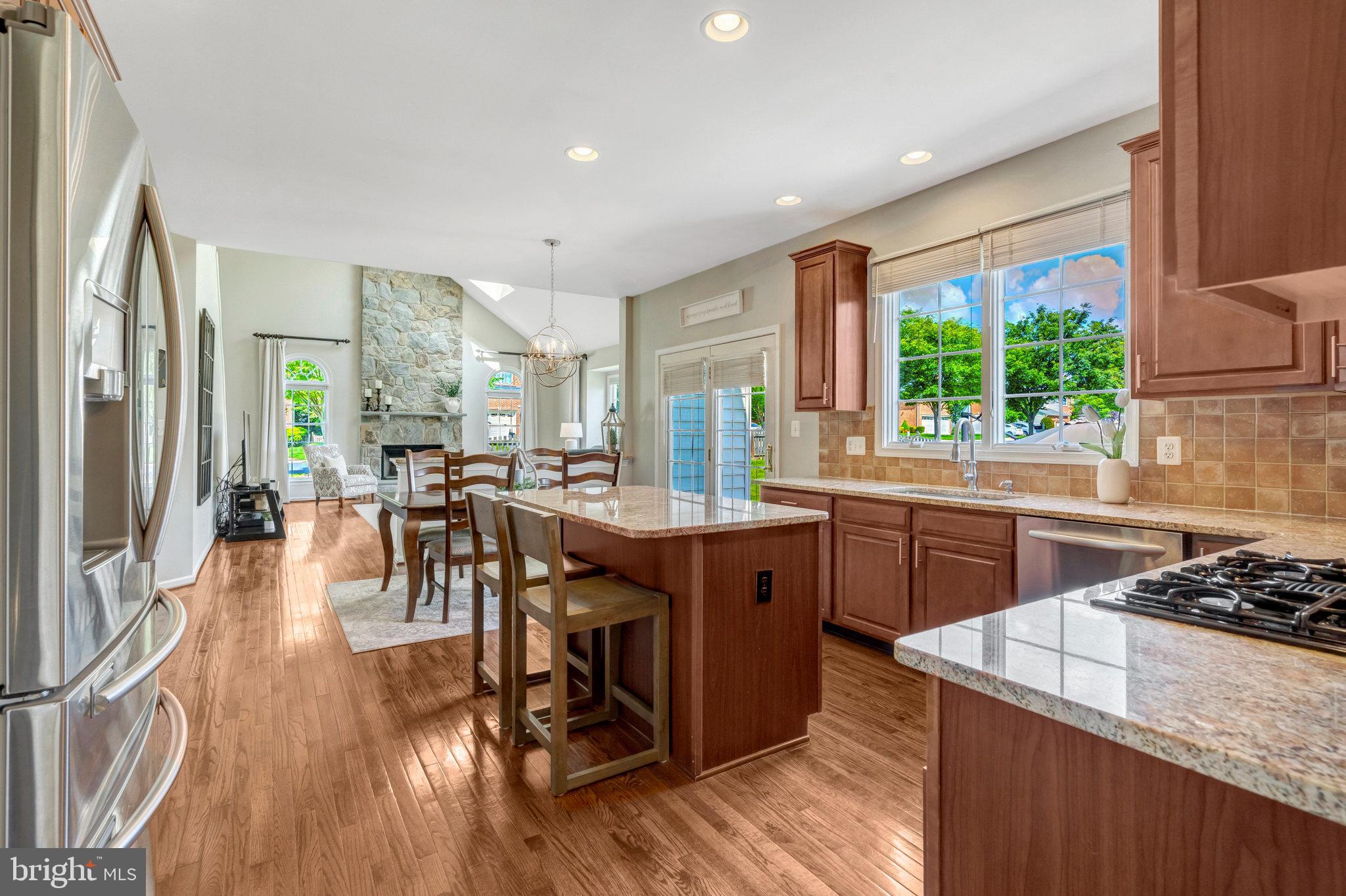 43058 Olive Tree Lane Chantilly, VA 20152 - Photo 11 of 27 a kitchen with stainless steel appliances granite countertop sink stove top oven and cabinets
