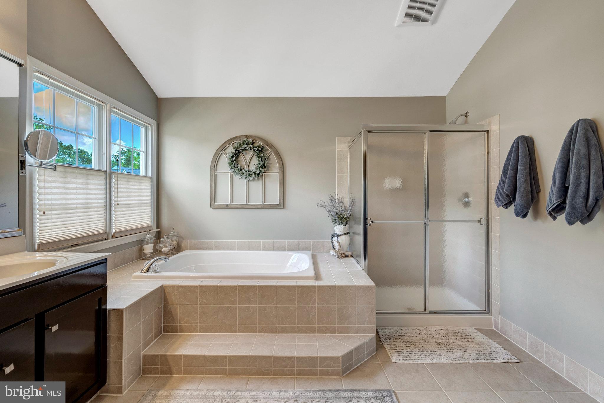 43058 Olive Tree Lane Chantilly, VA 20152 - Photo 20 of 27 a spacious bathroom with a bathtub and a shower