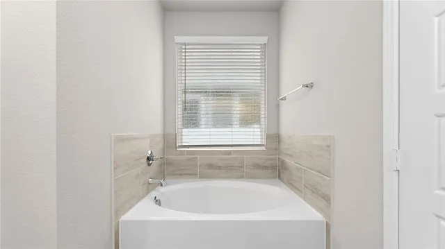 a white bath tub sitting next to a window