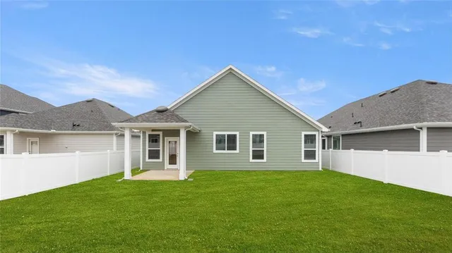 a view of a house with a backyard