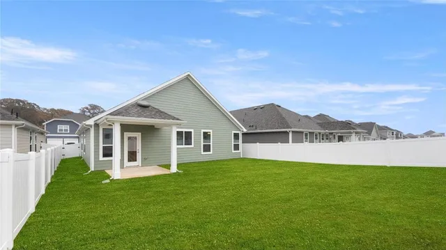 a view of a house with a yard and a porch