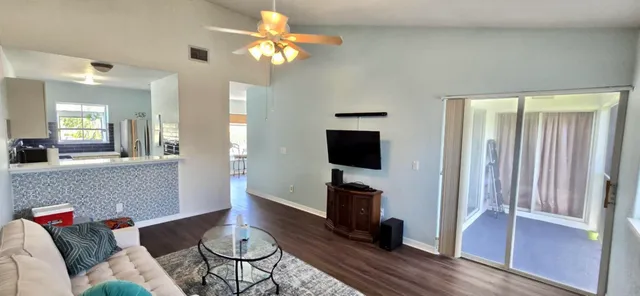 a white bath tub sitting next to a white sink and vanity