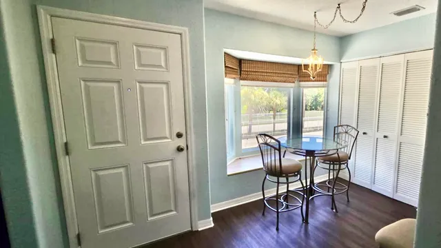 a view of a room with furniture and wooden floor
