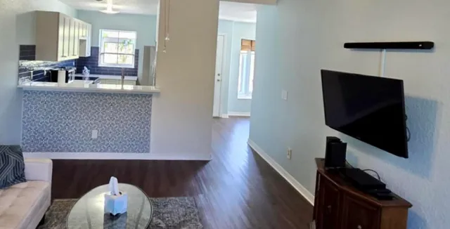 an empty room with wooden floor and entrance