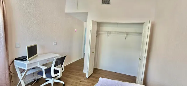 a view of backyard with outdoor seating and plants