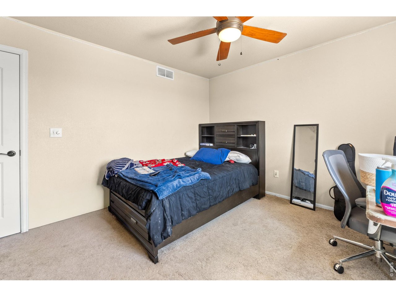 8847 16th St Road Greeley, CO 80634 - Photo 29 of 38 a bedroom with a bed and a chandelier