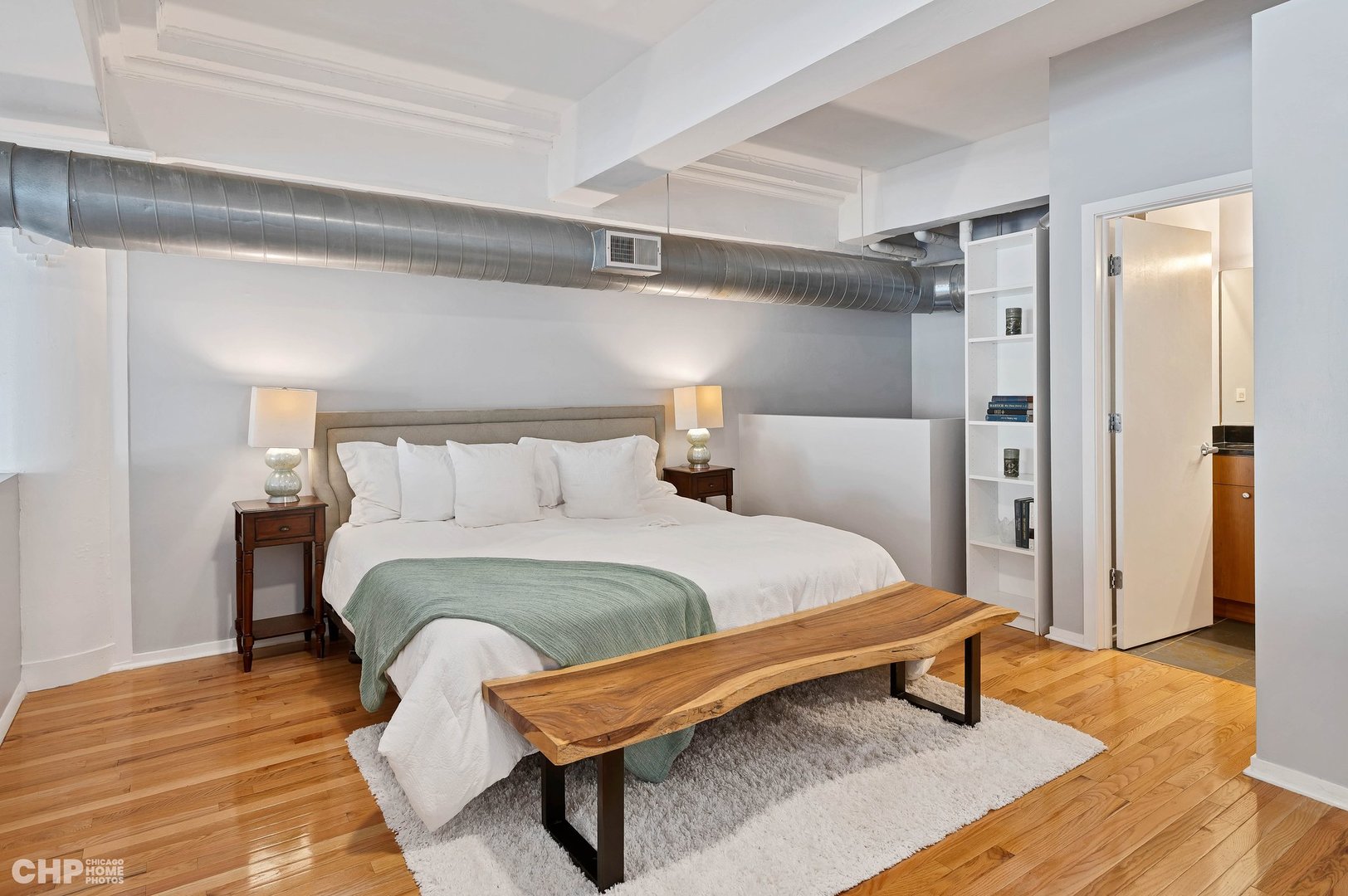 2000 South Michigan Avenue, Unit 107 Chicago, IL 60616 - Photo 12 of 30 a bedroom with a bed and wooden floor