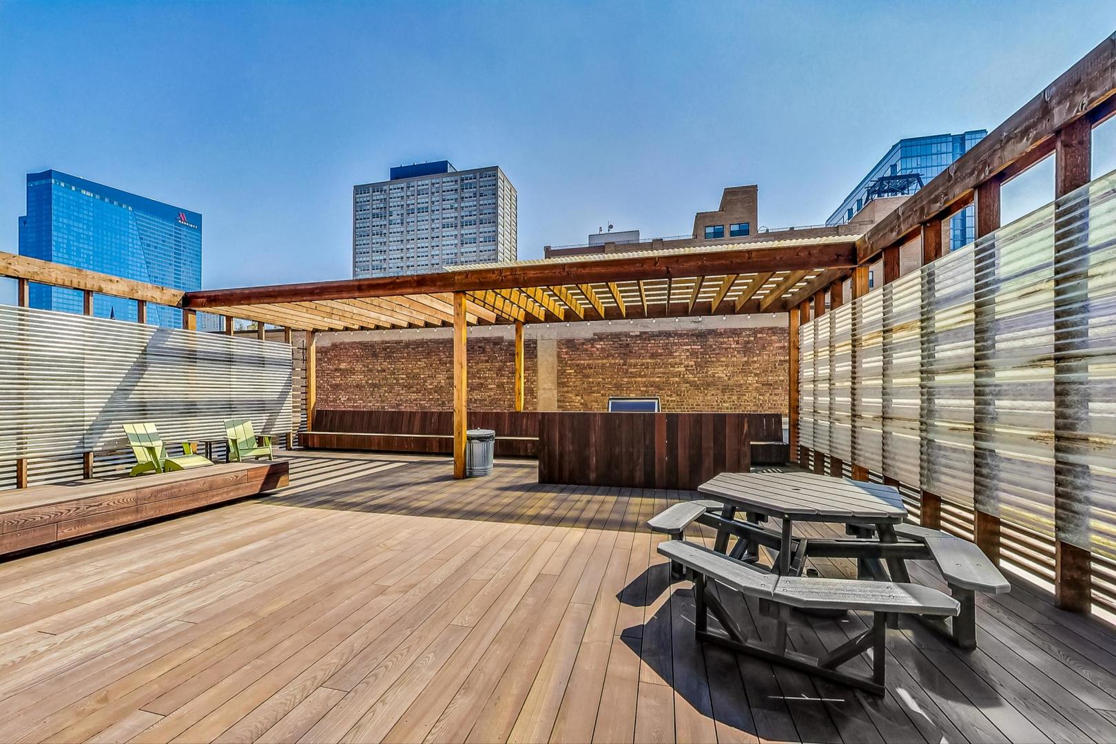 2000 South Michigan Avenue, Unit 107 Chicago, IL 60616 - Photo 27 of 30 a view of a patio with table and chairs with wooden floor