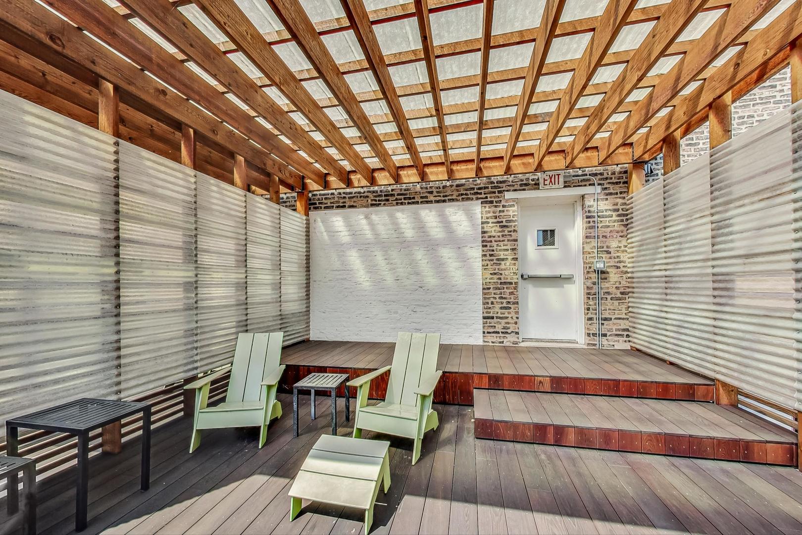 2000 South Michigan Avenue, Unit 107 Chicago, IL 60616 - Photo 29 of 30 a roof deck with wooden floor and outdoor seating