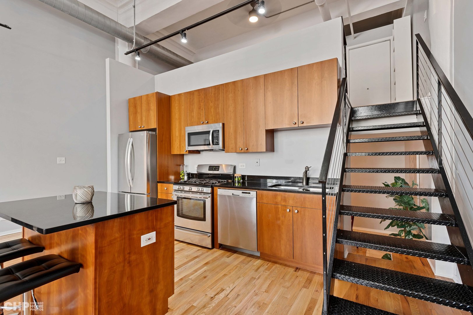 2000 South Michigan Avenue, Unit 107 Chicago, IL 60616 - Photo 8 of 30 a kitchen with stainless steel appliances granite countertop a refrigerator a stove and a wooden floors
