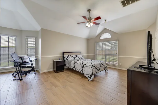 a bedroom with furniture window and a ceiling fan