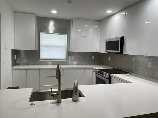 a kitchen that has a sink and a stove in it