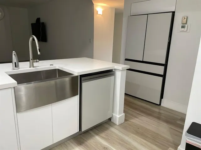 a kitchen with a sink and a refrigerator