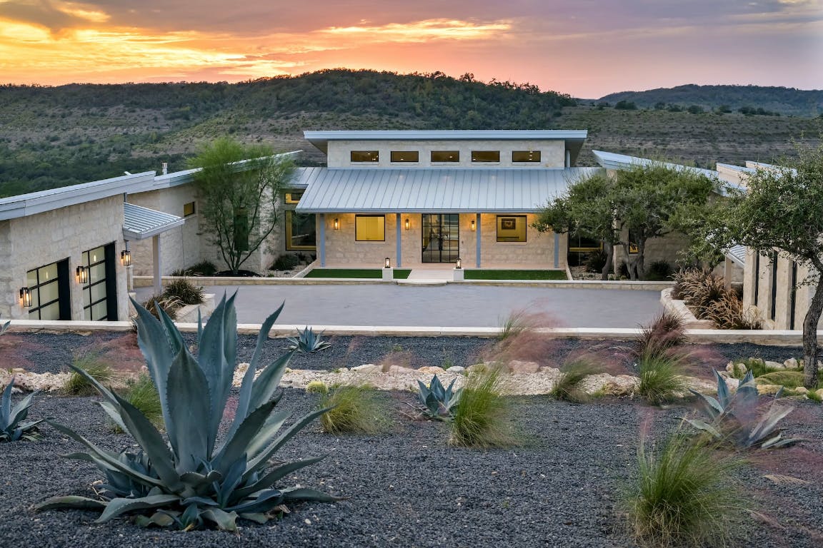 a front view of a house with garden