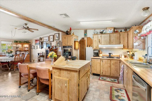 a kitchen with a sink appliances and cabinets