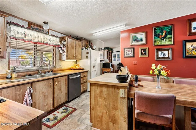 a kitchen with stainless steel appliances kitchen island granite countertop a sink and cabinets