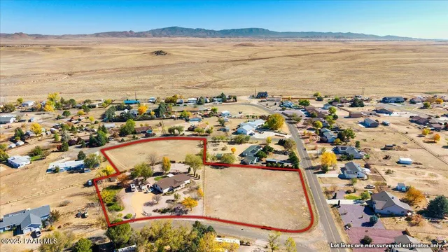 an aerial view of ocean and residential houses with outdoor space
