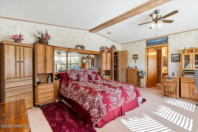 a bedroom with a large bed and a chandelier