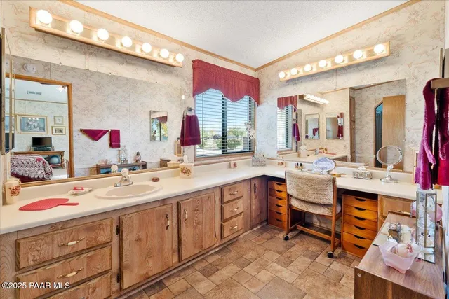 a bathroom with a double vanity sink toilet and shower