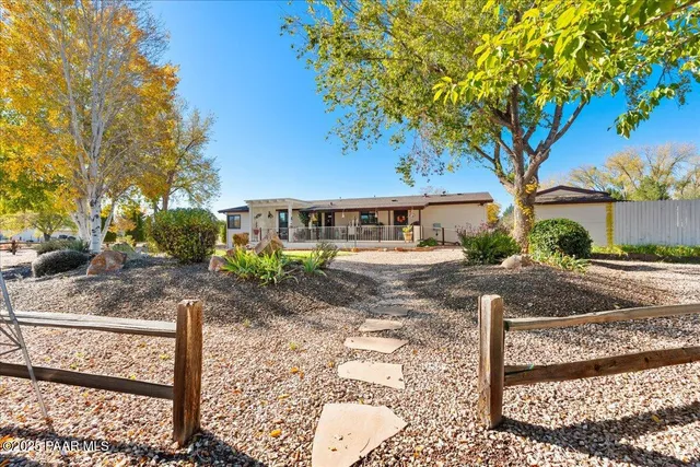 a view of a house with wooden fence and floor
