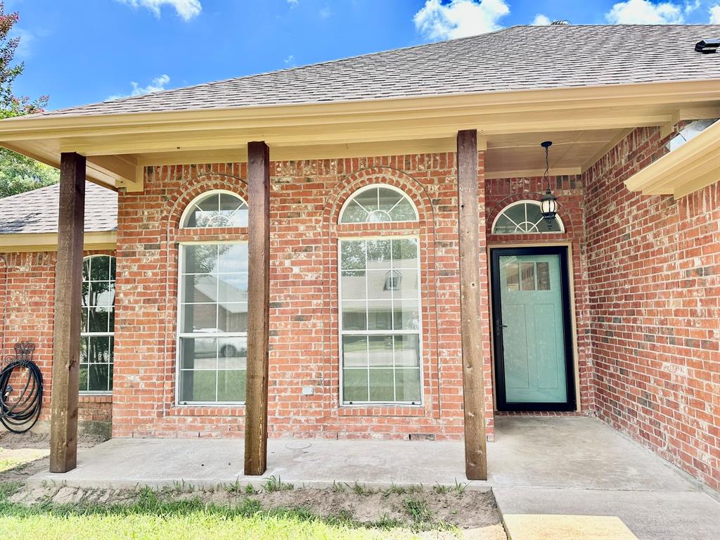 917 Calder Street Howe, TX 75459 - Photo 1 of 1 Property entrance with a shingled roof and brick siding