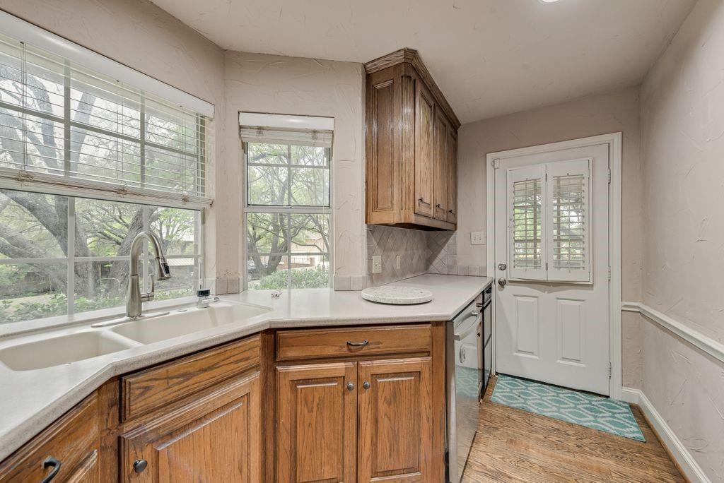 2 Eastshore Road Heath, TX 75032 - Photo 25 of 30 a kitchen with stainless steel appliances granite countertop a sink and a window