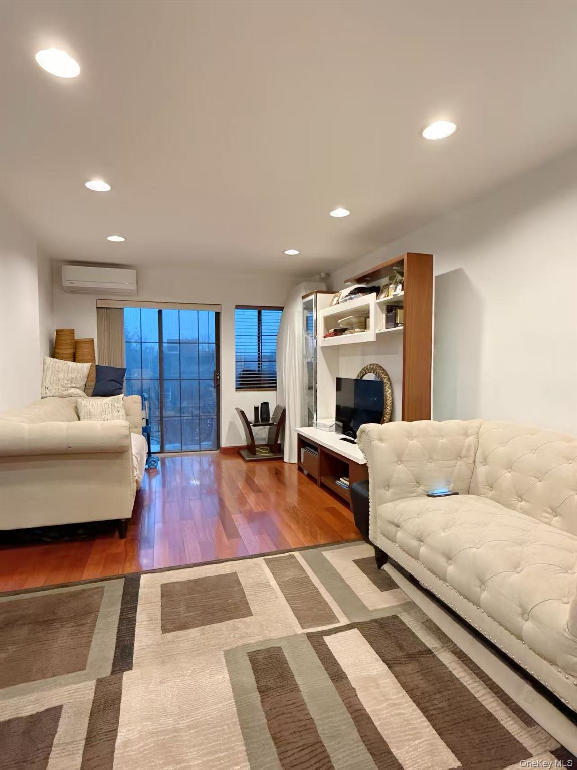 4260 Colden Street, Unit 3A Queens, NY 11355 - Photo 4 of 11 a living room with furniture and a fireplace