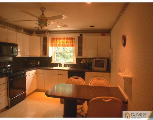 11 Highland Terrace Fords, NJ 08863 - Photo 2 of 6 a kitchen with stainless steel appliances granite countertop a stove a sink and a microwave