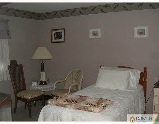 11 Highland Terrace Fords, NJ 08863 - Photo 5 of 6 a bed sitting in a bedroom and table chair