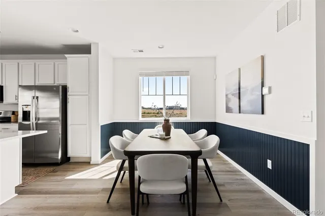 a dining room with furniture and window