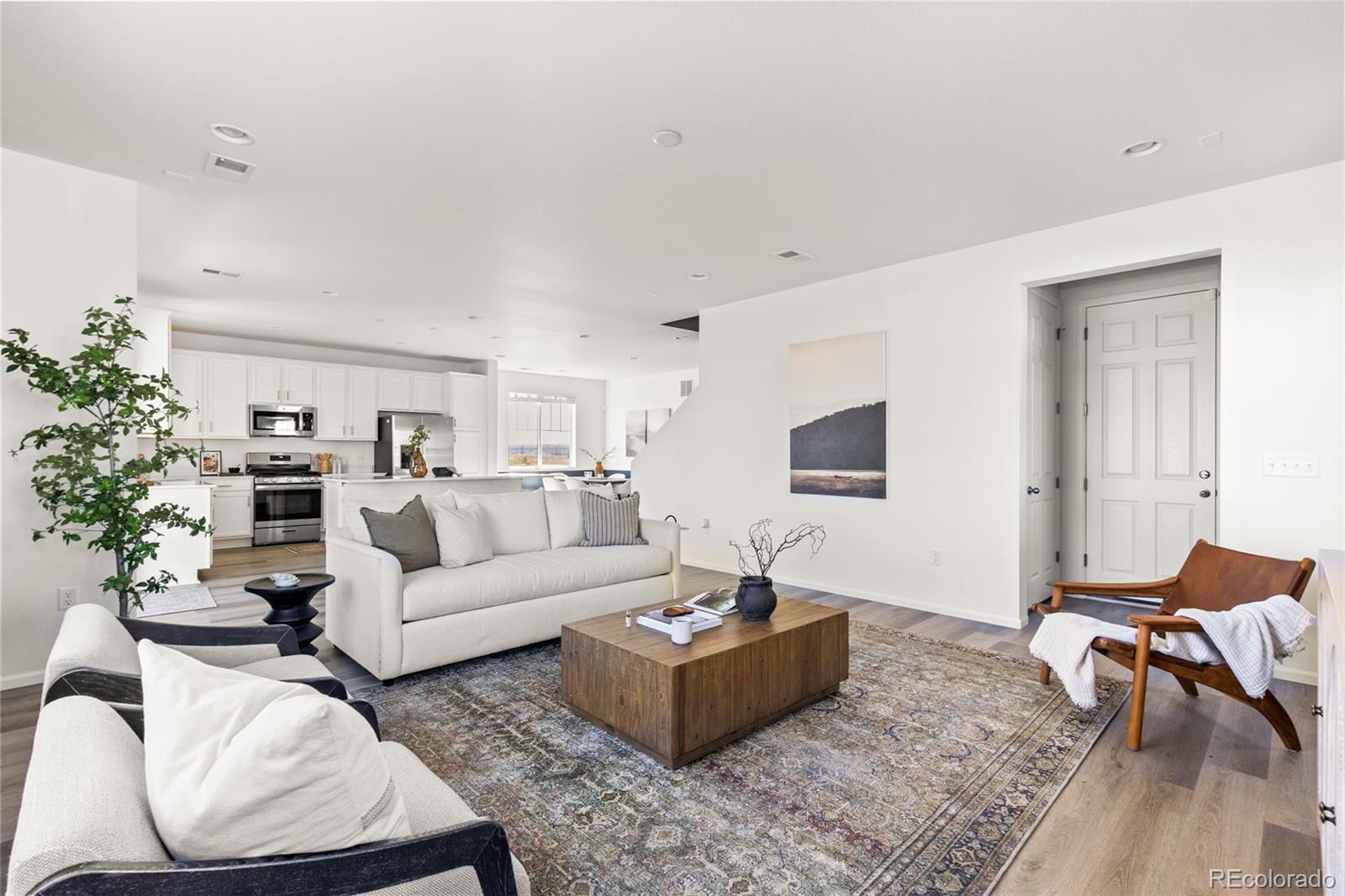 9054 Truckee Court Commerce City, CO 80022 - Photo 20 of 49 a living room with furniture a rug and a window