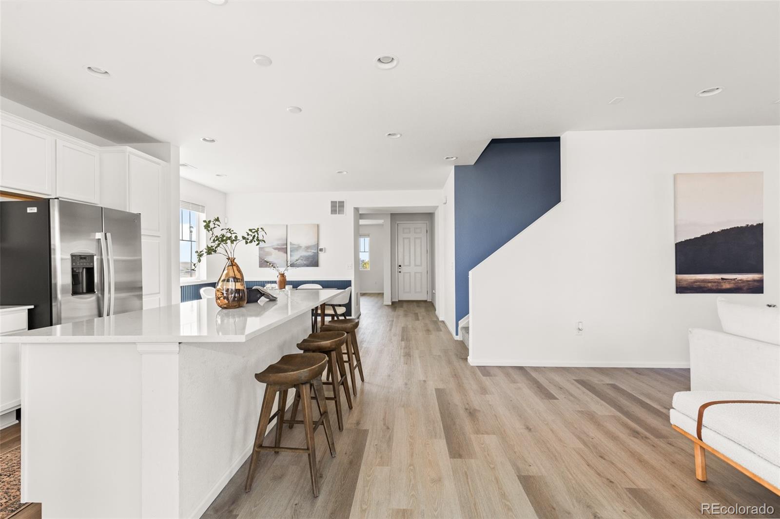 9054 Truckee Court Commerce City, CO 80022 - Photo 21 of 49 a living room with furniture and a wooden floor