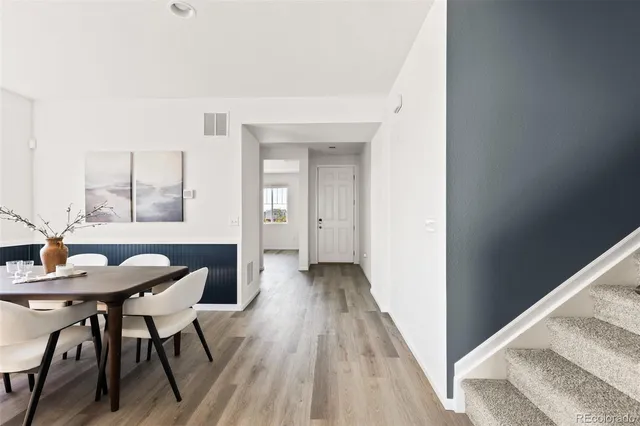 a view of a room with furniture and wooden floor
