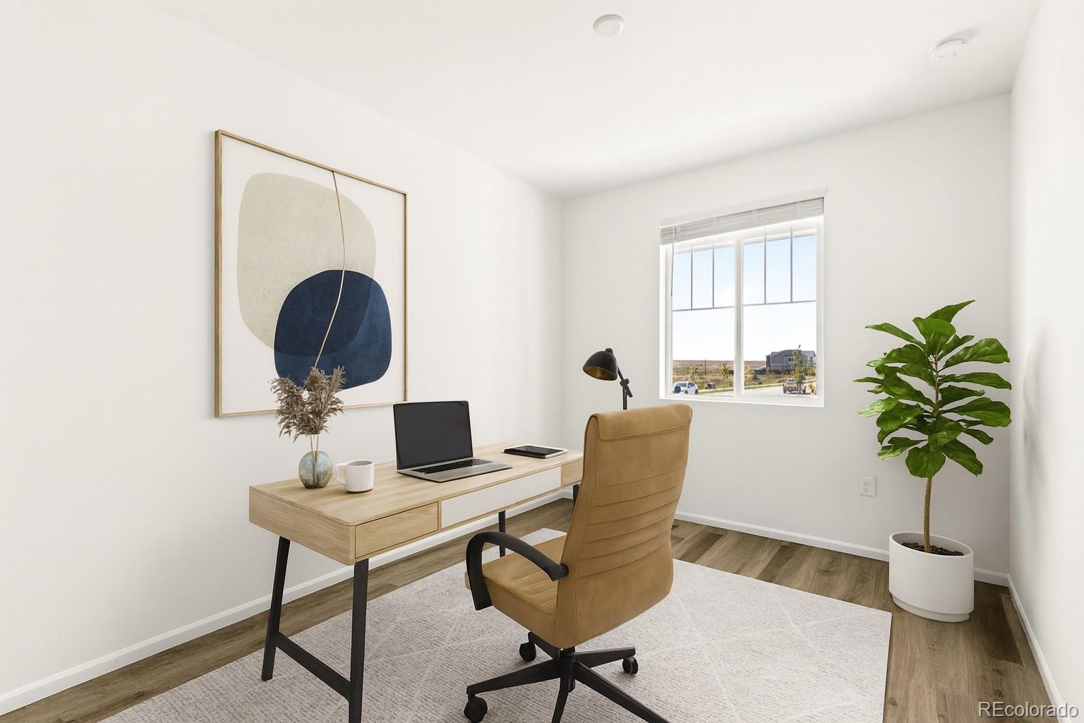 9054 Truckee Court Commerce City, CO 80022 - Photo 24 of 49 a workspace with furniture and a potted plant