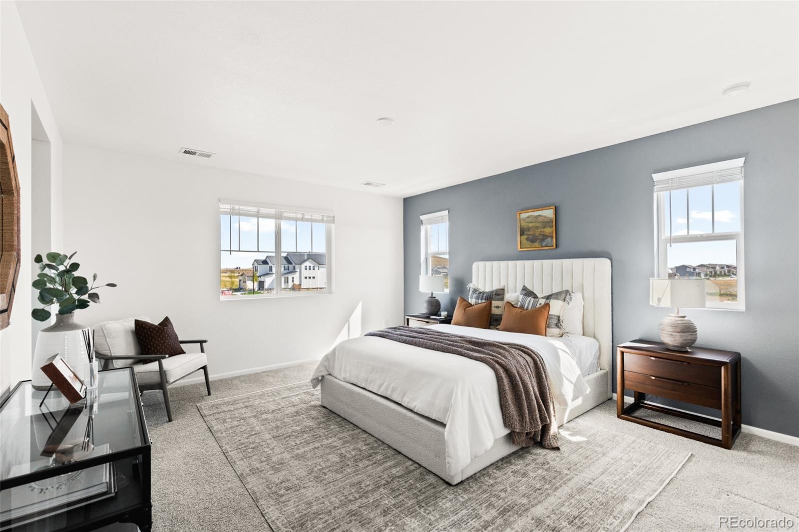 9054 Truckee Court Commerce City, CO 80022 - Photo 26 of 49 a bedroom with a bed and chair