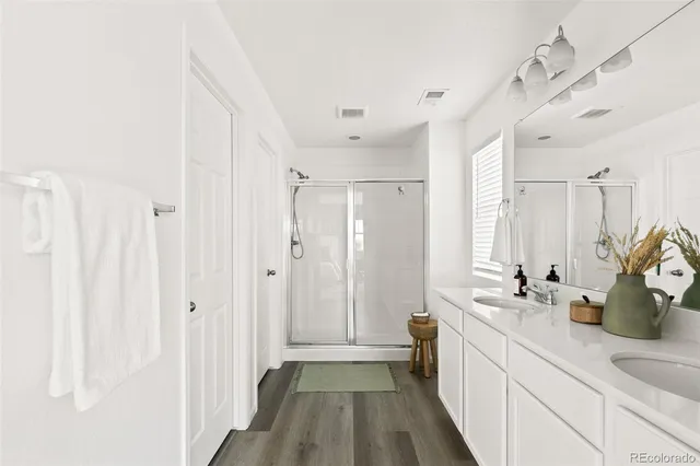 a bathroom with a double vanity sink and a mirror