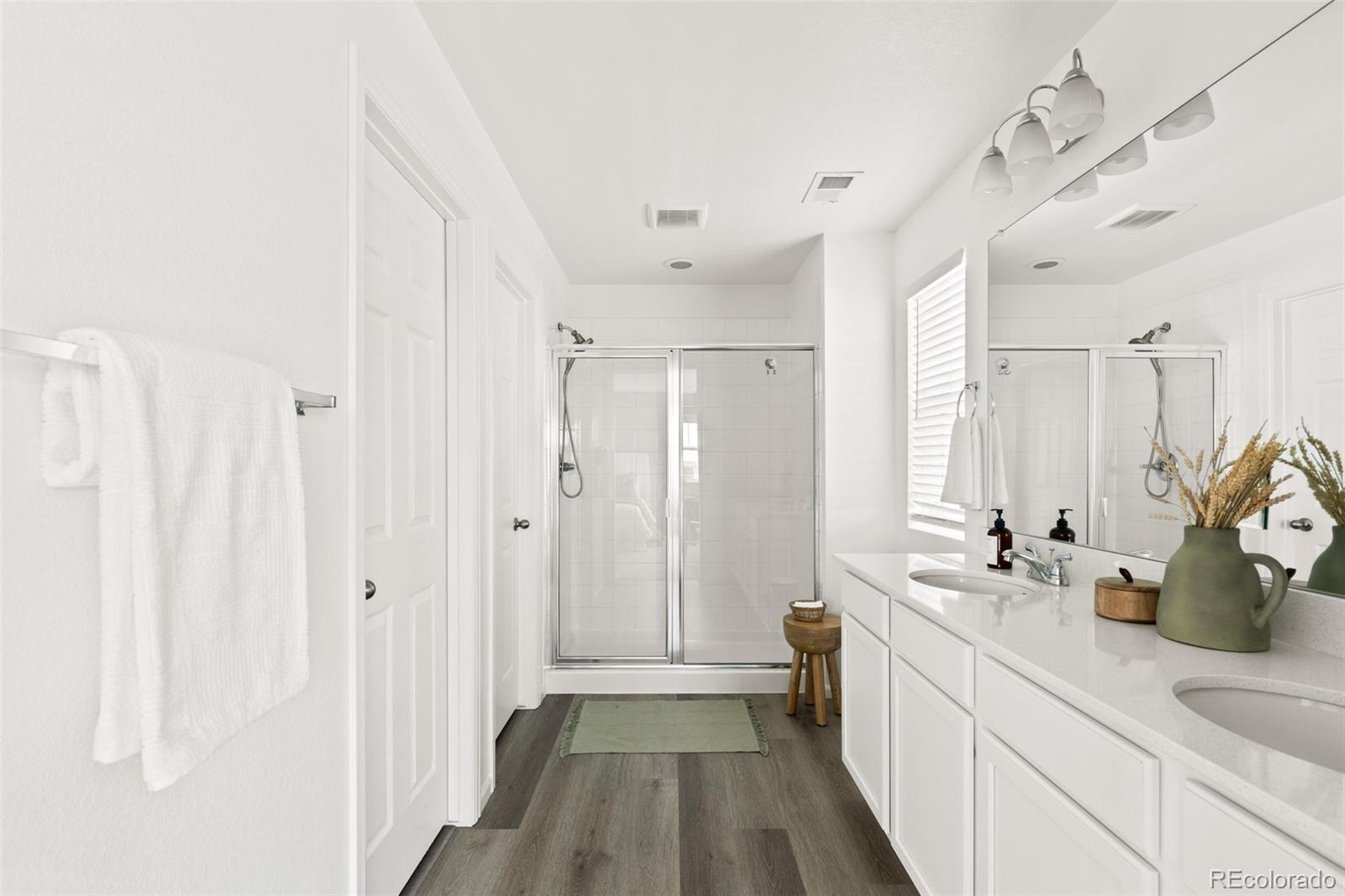 9054 Truckee Court Commerce City, CO 80022 - Photo 33 of 49 a bathroom with a double vanity sink and a mirror