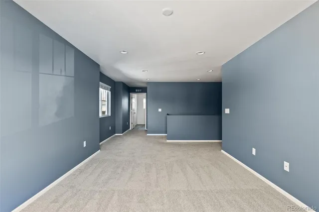 a view of a big room with a chandelier fan and window