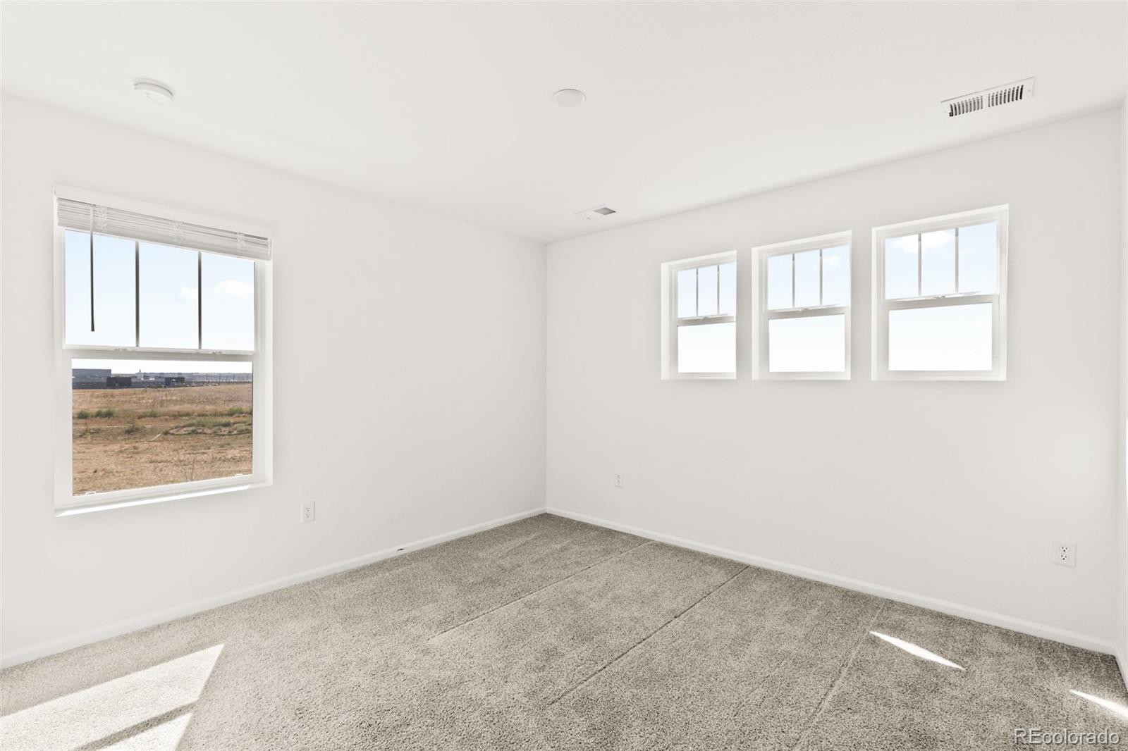 9054 Truckee Court Commerce City, CO 80022 - Photo 38 of 49 an empty room with windows