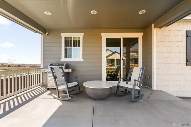 a view of a patio with a chairs and potted plants