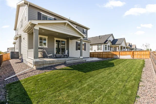 a view of a house with a backyard and a patio